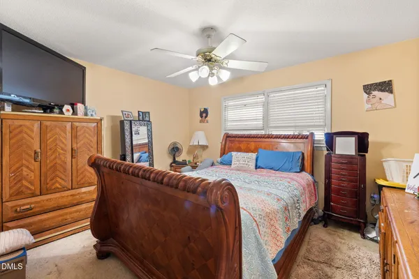 a bedroom with bed and window