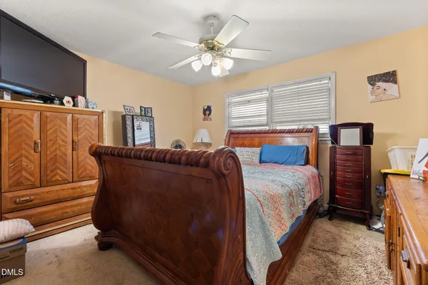a bedroom with a bed and window
