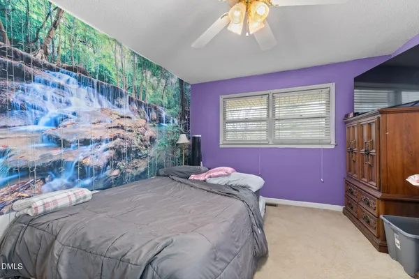 a bedroom with a bed dresser and a window