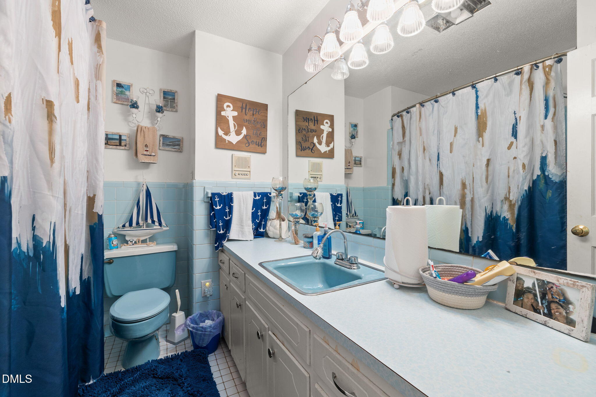 4017 Tryon Road Raleigh, NC 27606 - Photo 28 of 39 a bathroom with a toilet sink and mirror