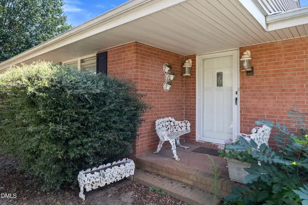 a view of a brick house with a yard