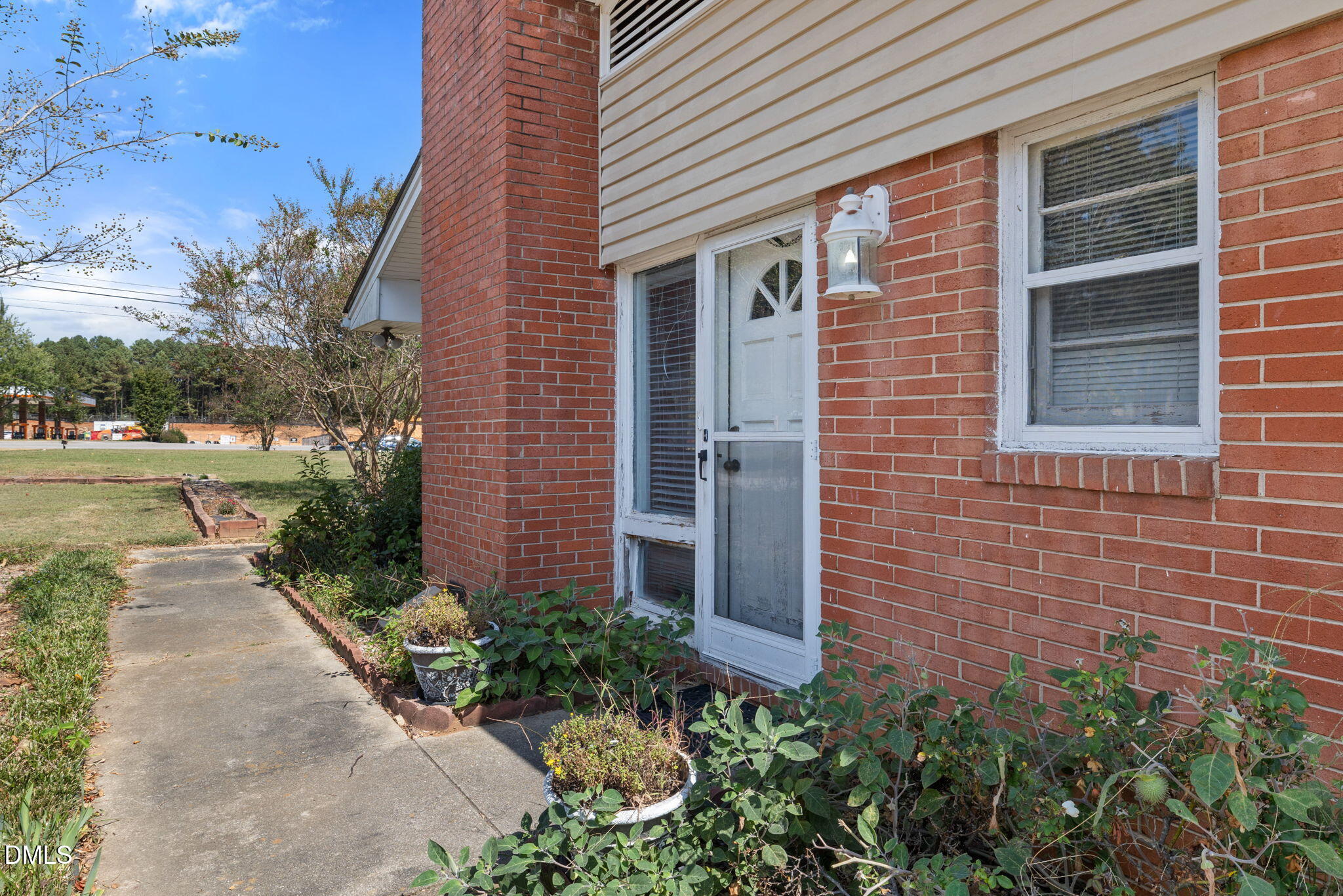 4017 Tryon Road Raleigh, NC 27606 - Photo 32 of 39 a view of a brick house with a yard