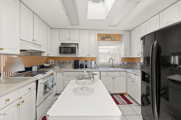 a kitchen with a stove a sink and a refrigerator