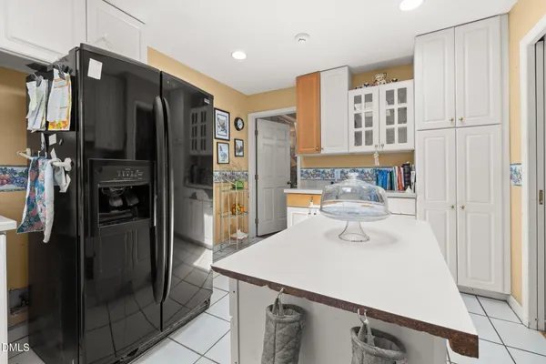 a kitchen with stainless steel appliances a refrigerator and cabinets