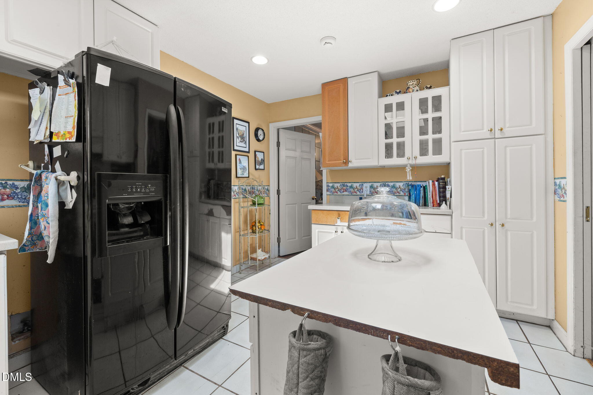 4017 Tryon Road Raleigh, NC 27606 - Photo 7 of 39 a kitchen with stainless steel appliances a refrigerator and cabinets