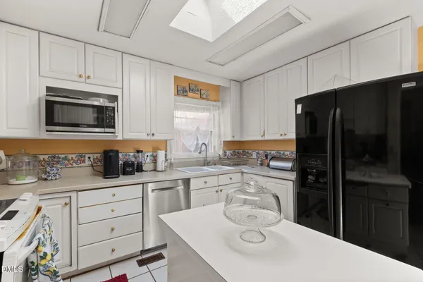 a kitchen with a sink a stove and refrigerator