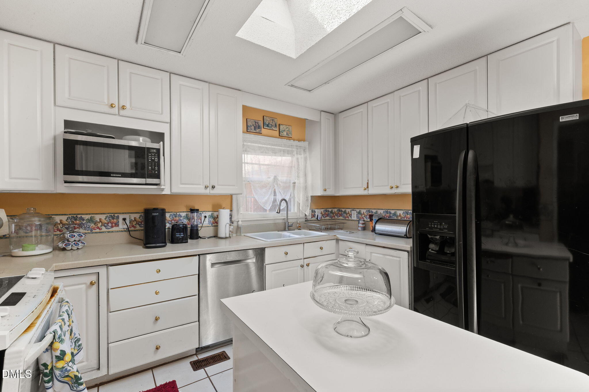 4017 Tryon Road Raleigh, NC 27606 - Photo 8 of 39 a kitchen with a sink a stove and refrigerator