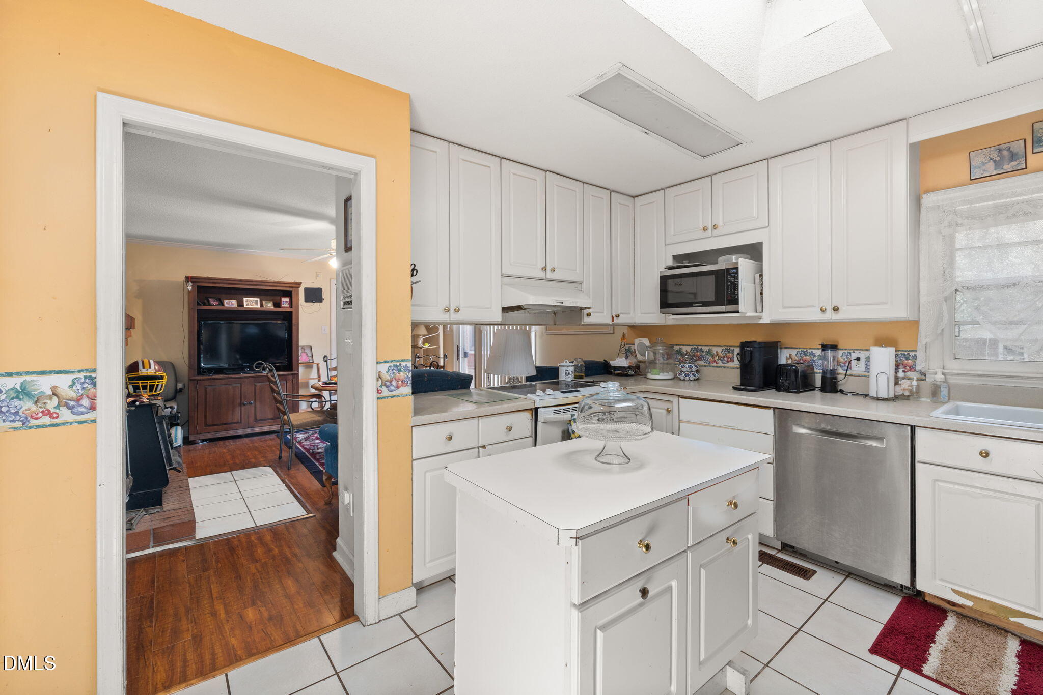 4017 Tryon Road Raleigh, NC 27606 - Photo 9 of 39 a kitchen with a sink stove and cabinets