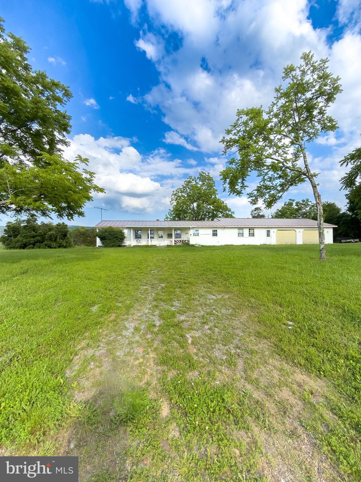 a view of yard with swimming pool and green space