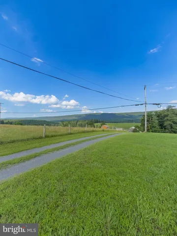 a view of a field of grass and a building