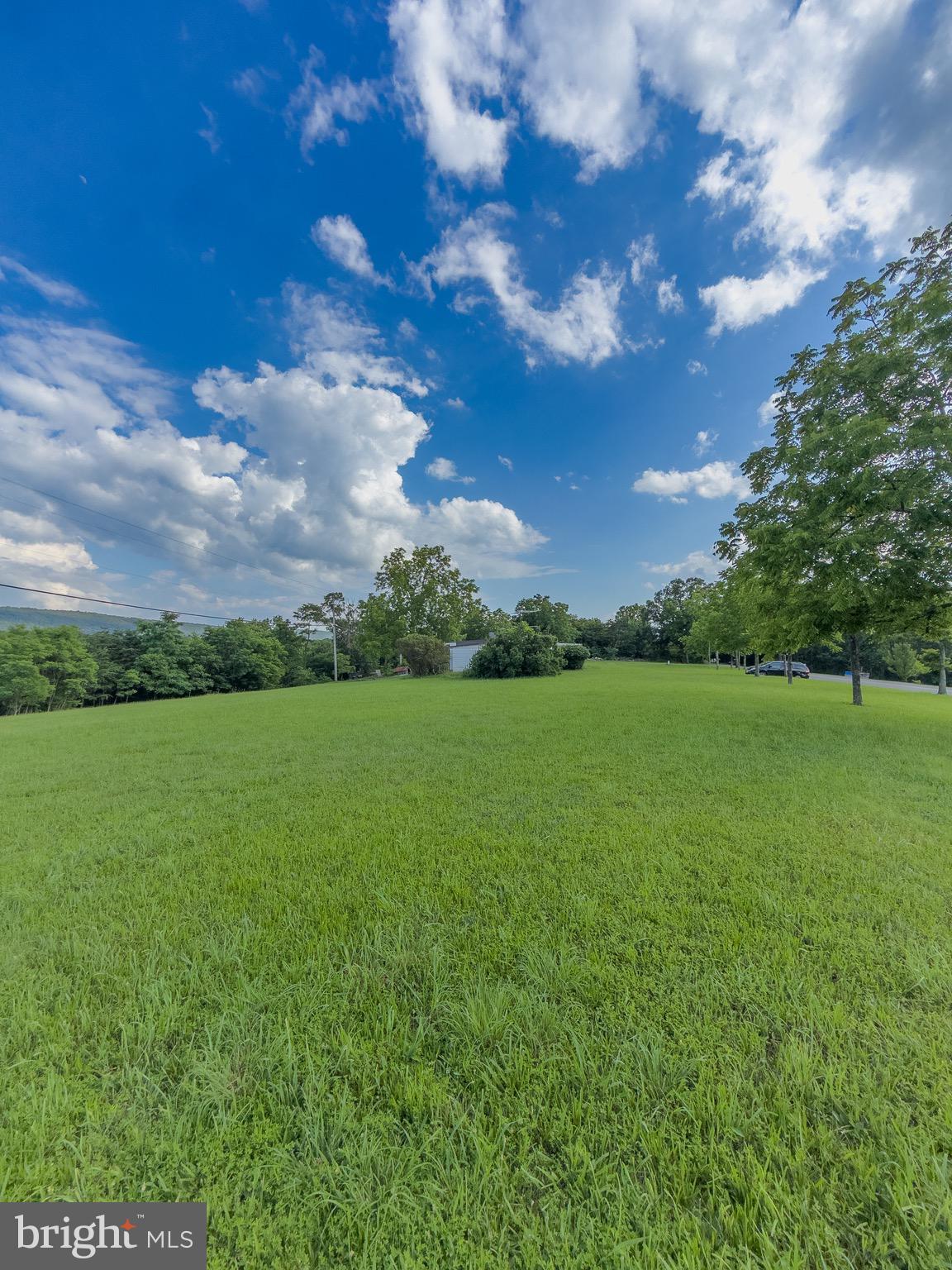 11101 Winchester Grade Road Berkeley Springs, WV 25411 - Photo 13 of 44 a view of a green field with wooden fence