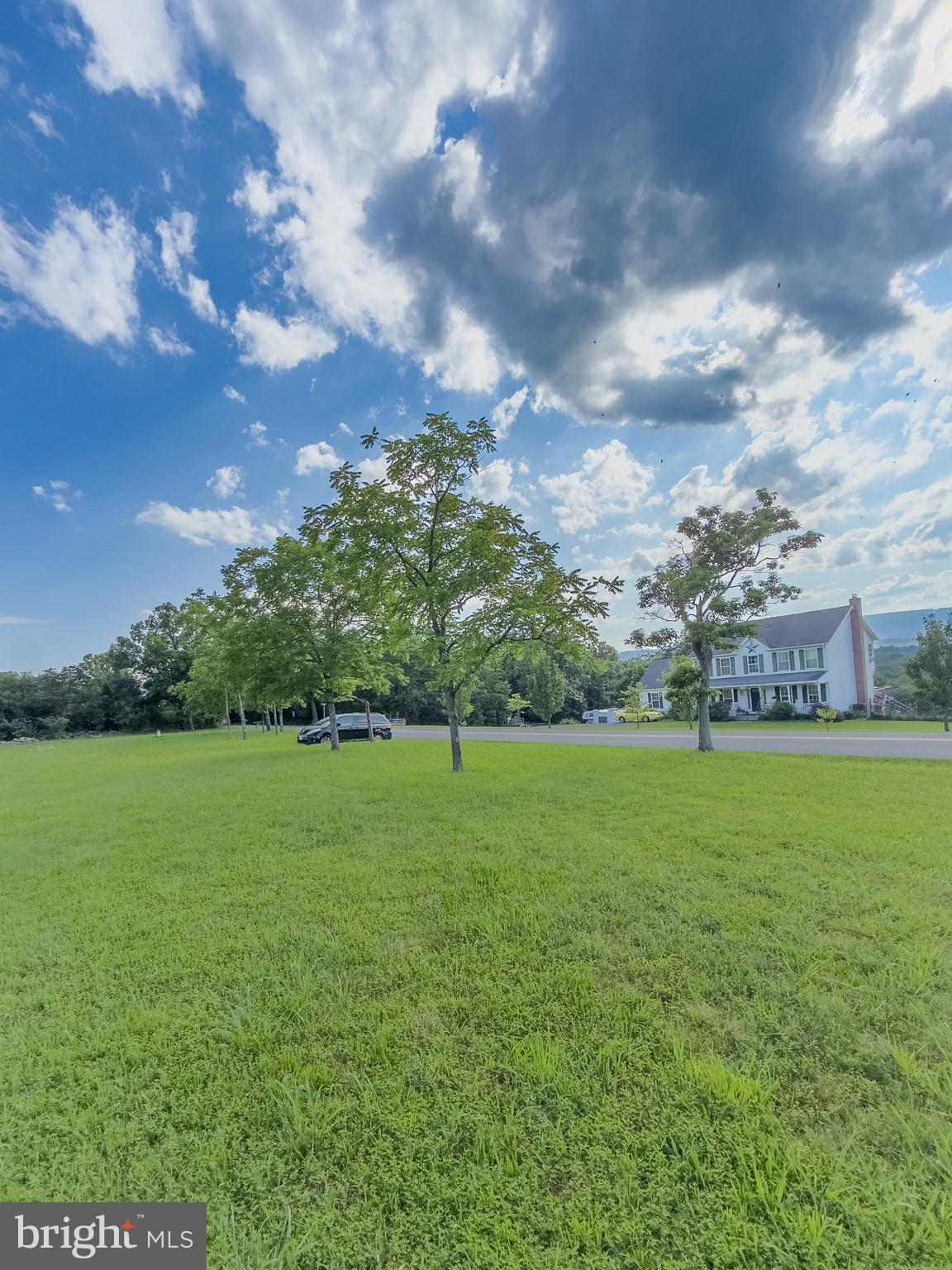 11101 Winchester Grade Road Berkeley Springs, WV 25411 - Photo 17 of 44 a view of a field of grass and trees