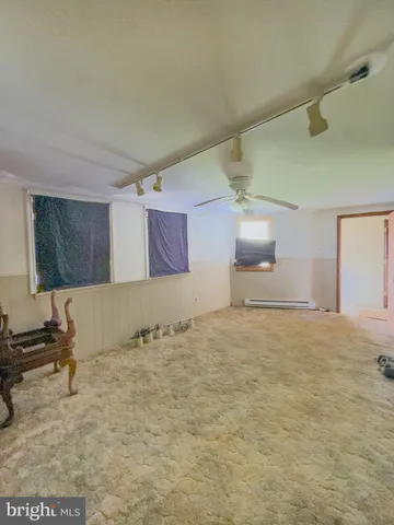 a spacious bedroom with a bed and lamp