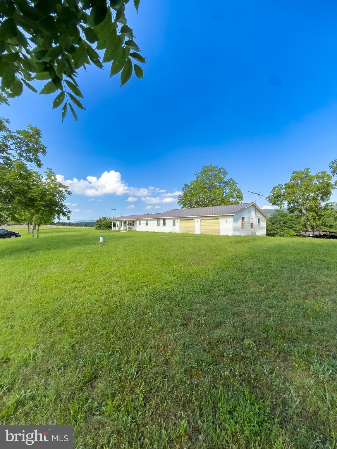 11101 Winchester Grade Road Berkeley Springs, WV 25411 - Photo 9 of 44 a view of a yard with a house in the background