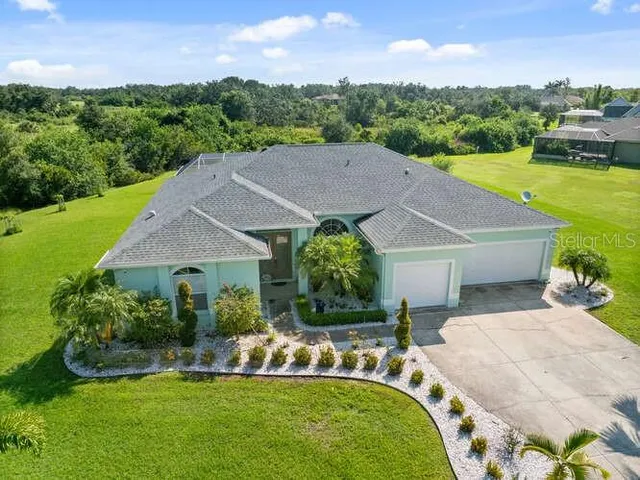a aerial view of a house with swimming pool garden and patio