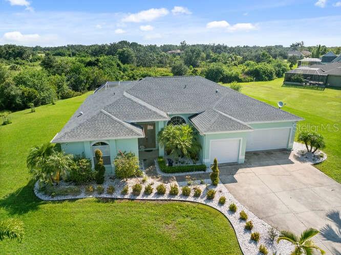 a aerial view of a house with swimming pool garden and patio