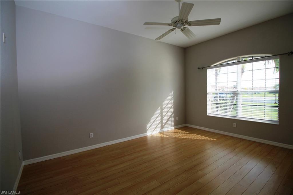 2086 Grove Drive Naples, FL 34120 - Photo 13 of 24 wooden floor in an empty room with a window