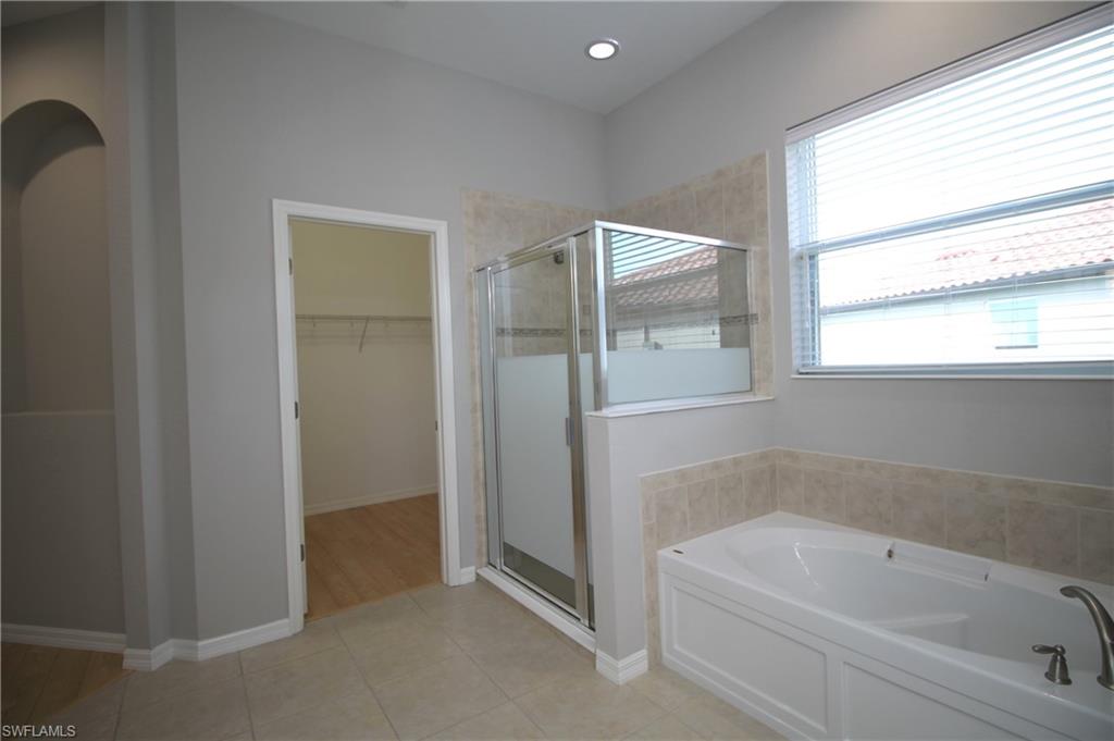 2086 Grove Drive Naples, FL 34120 - Photo 18 of 24 a bathroom with a bathtub and a shower