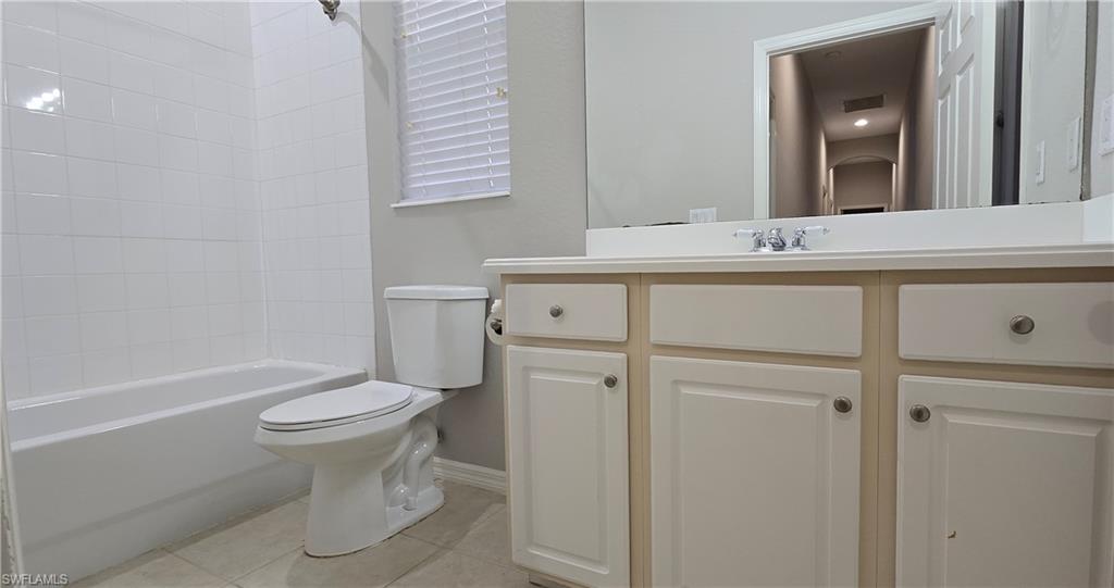 2086 Grove Drive Naples, FL 34120 - Photo 22 of 24 a bathroom with a sink toilet vanity and tub