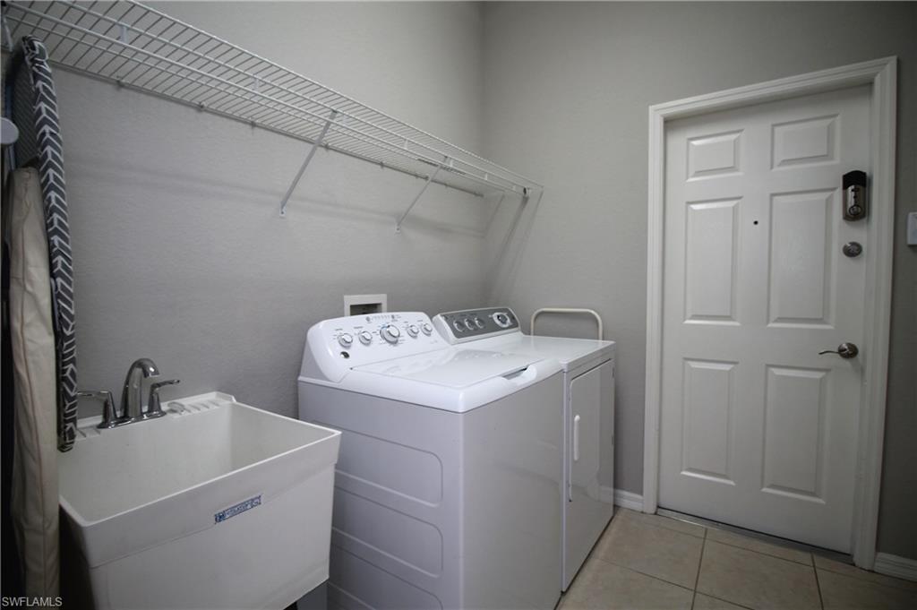 2086 Grove Drive Naples, FL 34120 - Photo 24 of 24 a utility room with dryer and washer