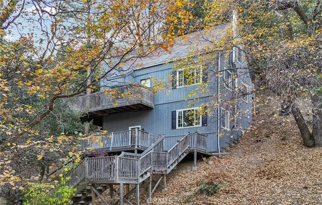 a view of a house with wooden fence