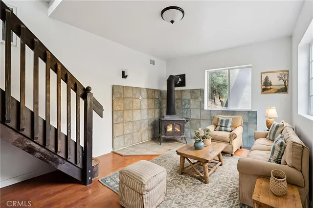 a living room with furniture stairs and a window