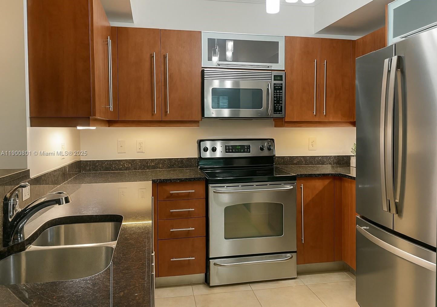 7355 Southwest 89th Street, Unit 501N Miami, FL 33156 - Photo 2 of 24 a kitchen with stainless steel appliances granite countertop a refrigerator stove and sink