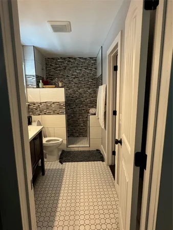 a living room with furniture pool table and a flat screen tv