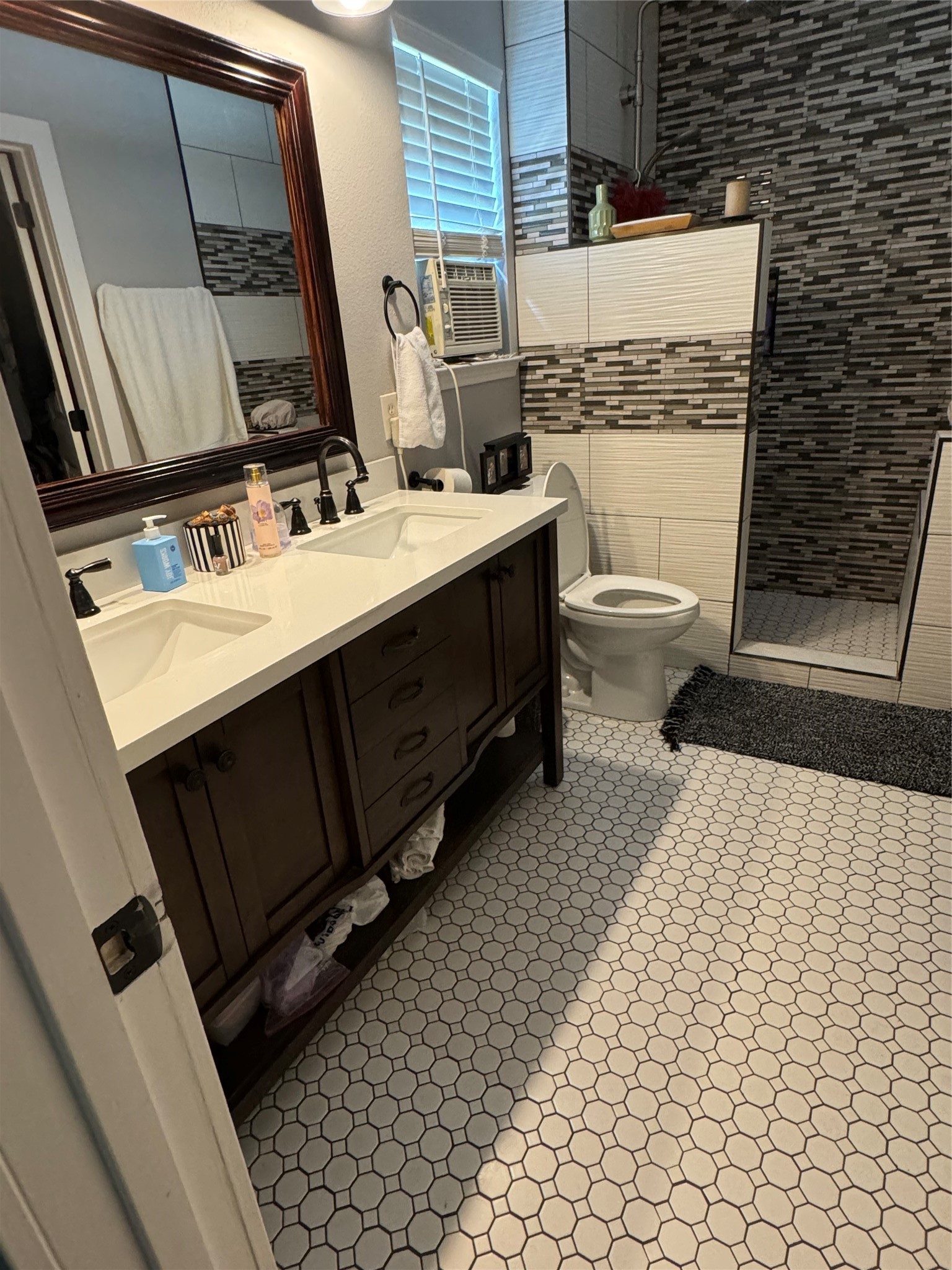 291 Brian Lane Kyle, TX 78640 - Photo 25 of 34 a bathroom with a sink a toilet and mirror