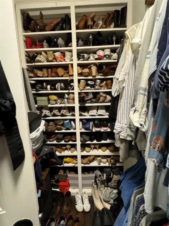 a bedroom with a bed and a flat tv screen on the dresser