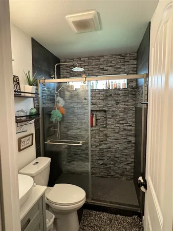 a living room with a flat screen tv and a refrigerator