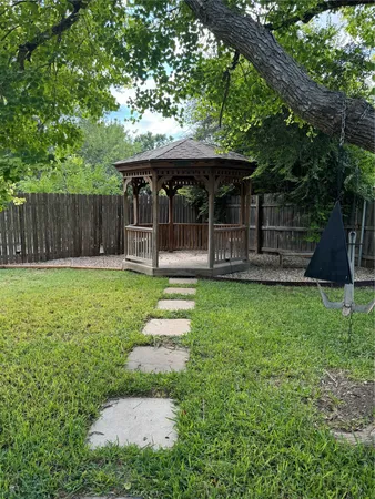 a front view of house with a garden