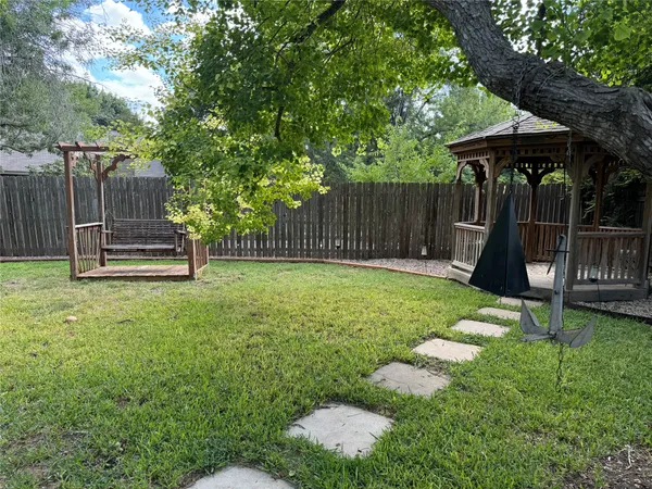 a backyard of a house with trampoline