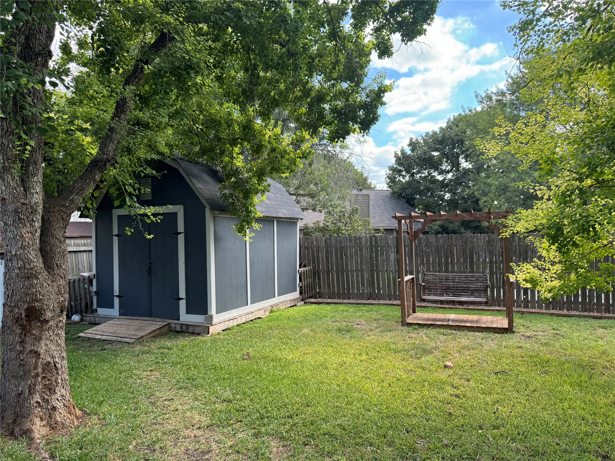 291 Brian Lane Kyle, TX 78640 - Photo 6 of 34 a backyard of a house with trampoline