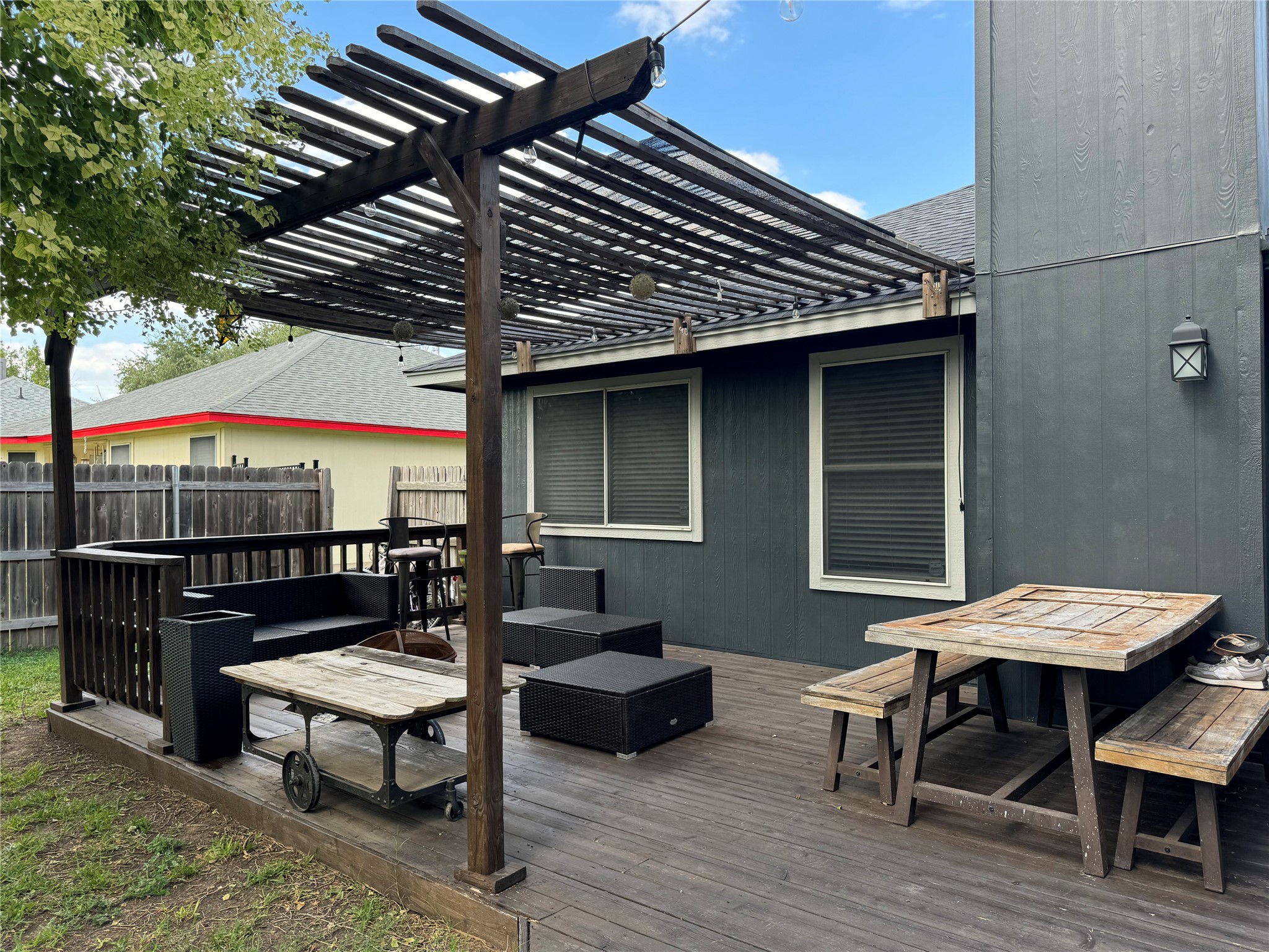 291 Brian Lane Kyle, TX 78640 - Photo 7 of 34 a view of a patio with table and chairs with wooden floor and fence