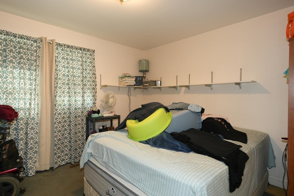 103 Devon Street Boston, MA 02121 - Photo 13 of 28 a bedroom with a bed and a window