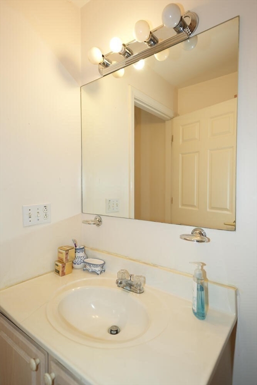 103 Devon Street Boston, MA 02121 - Photo 14 of 28 a bathroom with a sink and a mirror