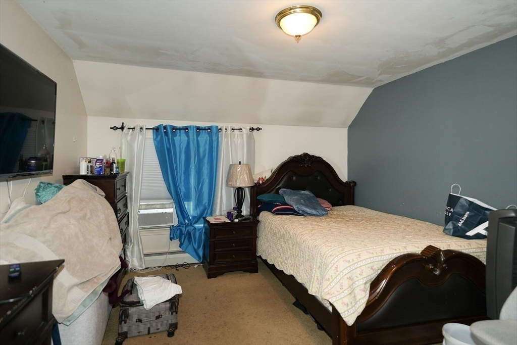 103 Devon Street Boston, MA 02121 - Photo 17 of 28 a bedroom with a bed and a flat screen tv