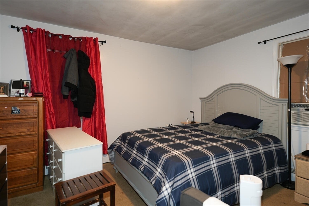 103 Devon Street Boston, MA 02121 - Photo 19 of 28 a bedroom with a bed and a dresser