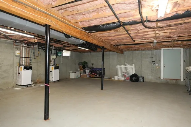 a view of a big room with air conditioner duct and materials on floor