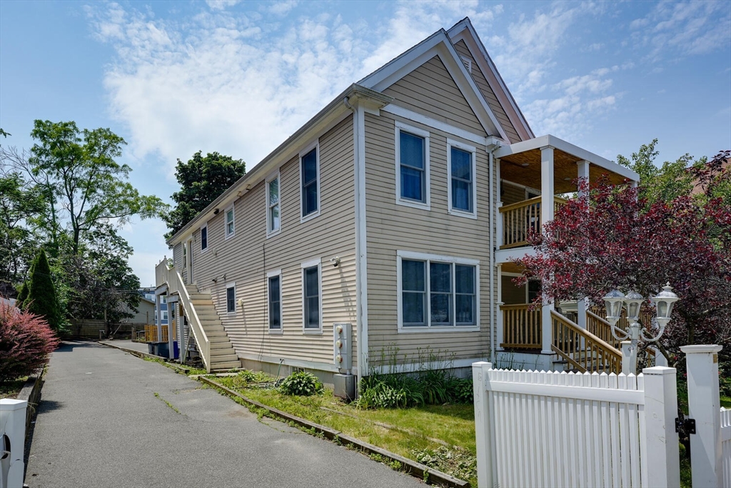 103 Devon Street Boston, MA 02121 - Photo 3 of 28 a front view of a house with a garden