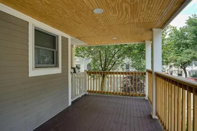 a view of balcony with wooden floor
