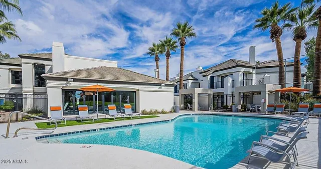 a view of a swimming pool with a lounge chairs