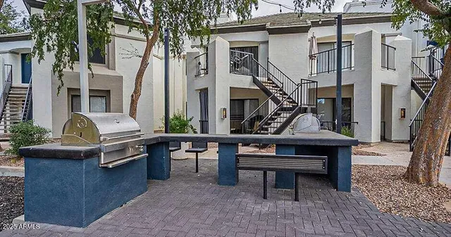 a view of a patio with table and chairs