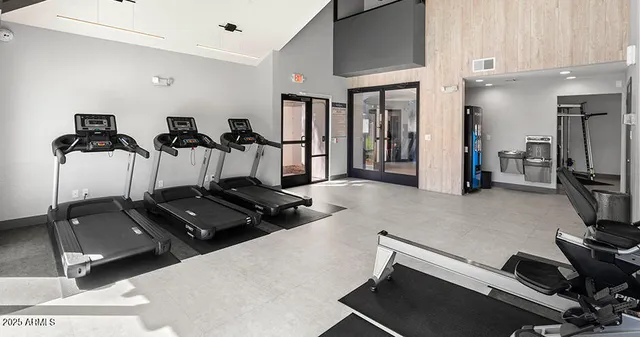 a room with gym equipment and a flat screen tv