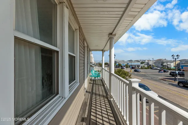 a view of a patio with couches table and chairs and potted plants