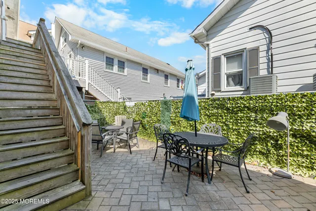 a kitchen with stainless steel appliances granite countertop a stove top oven a sink dishwasher a dining table and chairs with wooden floor