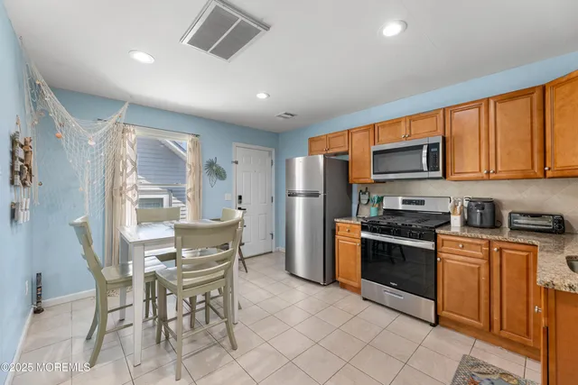 a bathroom with a toilet sink vanity and mirror