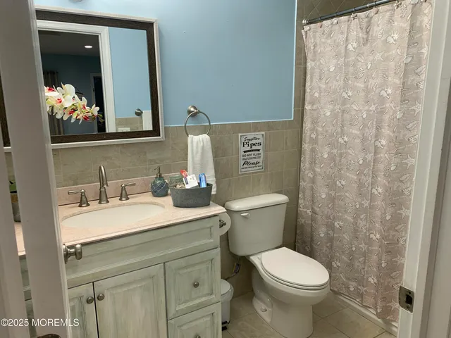 a kitchen with stainless steel appliances white cabinets and a stove a refrigerator with wooden floors