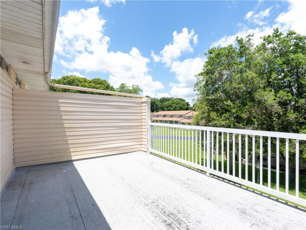 11001 Southeast Sunset Harbor Road, Unit 34 Summerfield, FL 34491 - Photo 22 of 31 View of patio / terrace with a balcony